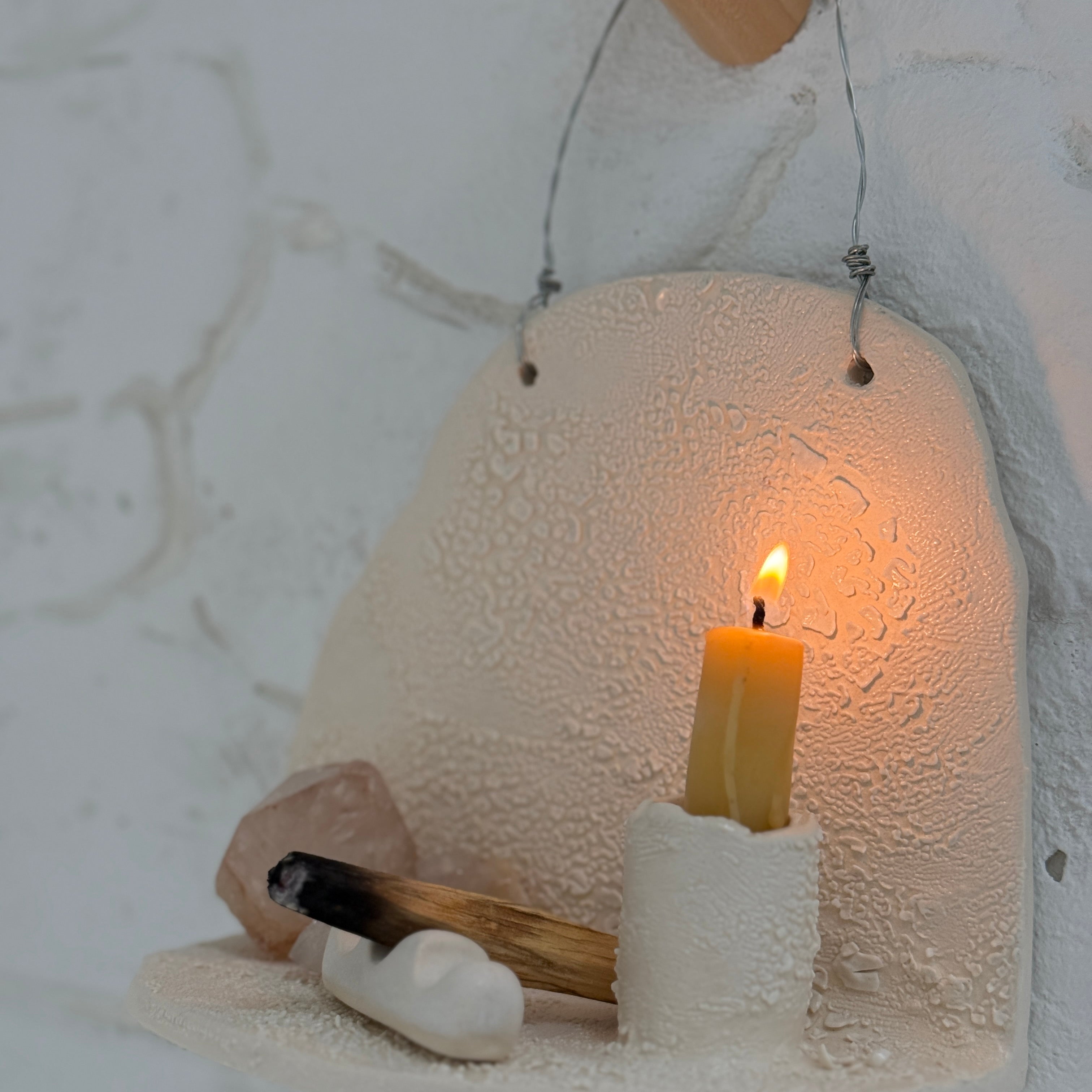 Handmade ceramic wall shelf altar for displaying crystals, candles, or palo santo.