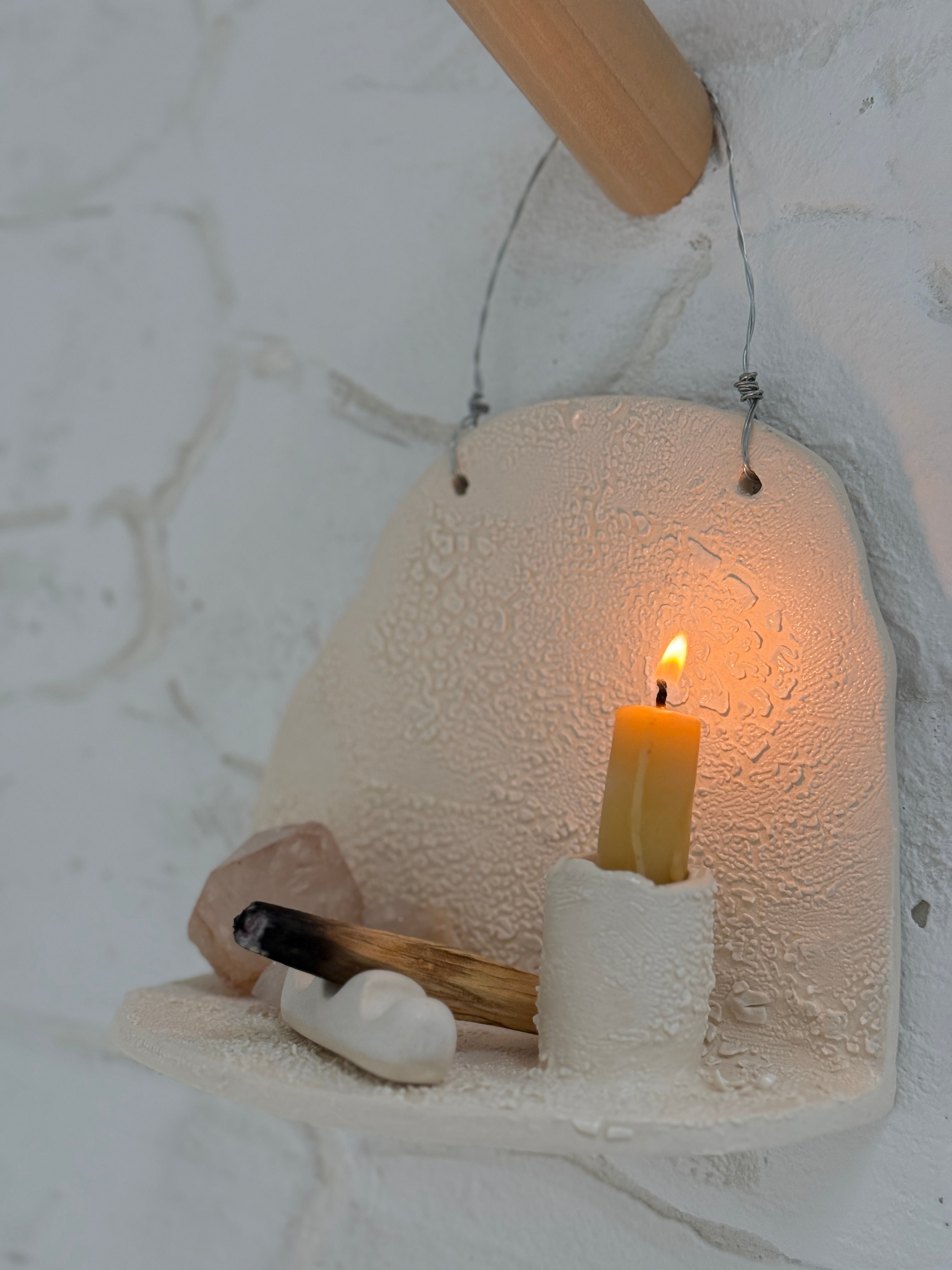 Handmade ceramic wall shelf altar for displaying crystals, candles, or palo santo.