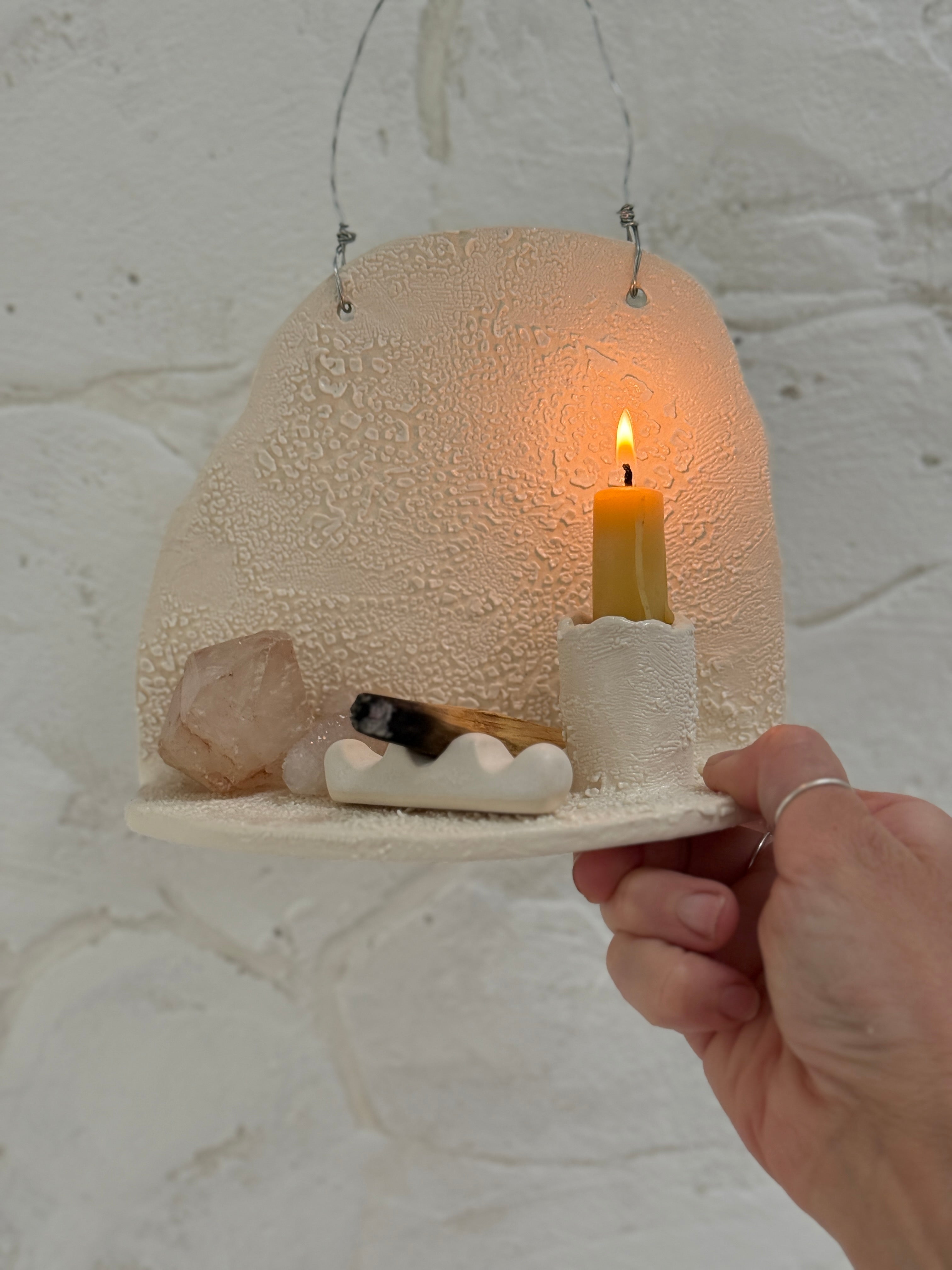 Handmade ceramic wall shelf altar for displaying crystals, candles, or palo santo.