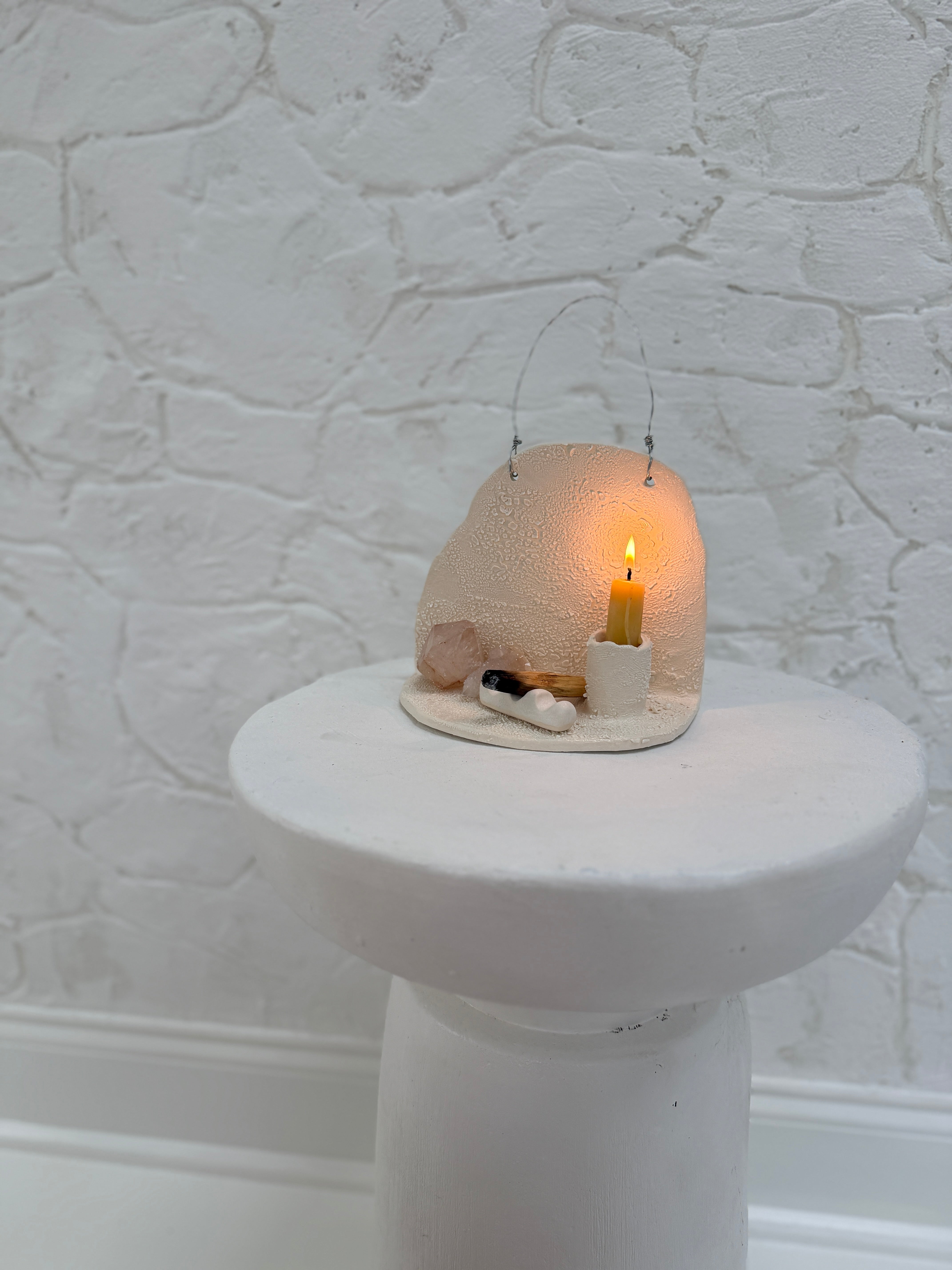 Handmade ceramic wall shelf altar for displaying crystals, candles, or palo santo.