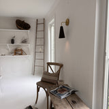 Handmade conical ceramic wall sconce with a raw brass wall canopy
