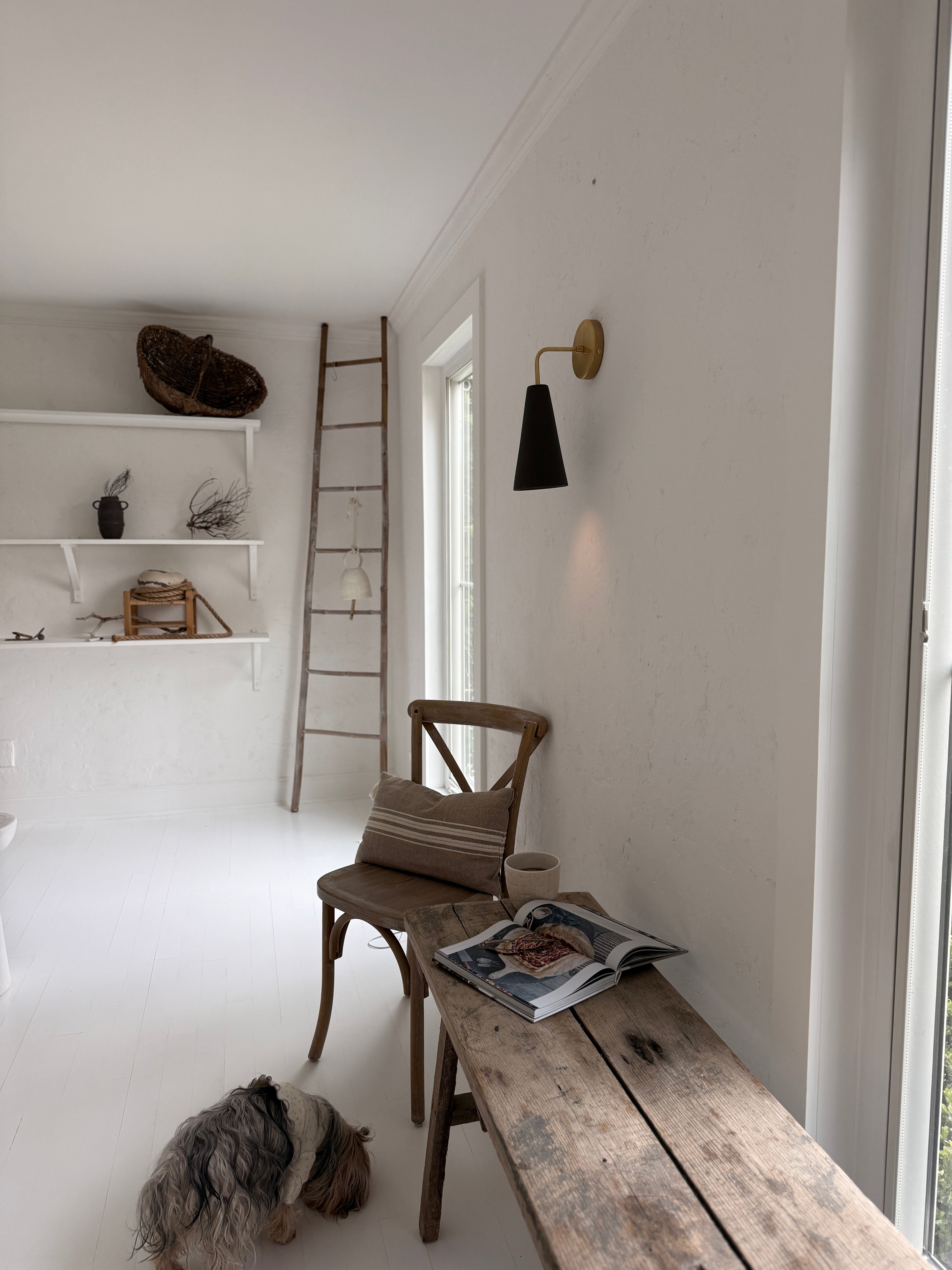 Handmade conical ceramic wall sconce with a raw brass wall canopy