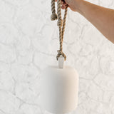 Handmade ceramic Loki bell in a neutral finish, hung for indoor or covered outdoor decor