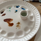 Handmade ceramic watercolor paint palette with mixing wells, a small water cup, and a brush holder.