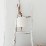 Handmade ceramic Loki bell in a neutral finish, hung for indoor or covered outdoor decor