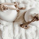 Handmade ceramic Loki bell in a neutral finish, hung for indoor or covered outdoor decor