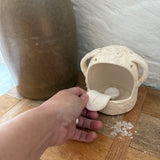 Whimsical handmade ceramic salt cellar shaped like Stanley, a googly-eyed monster