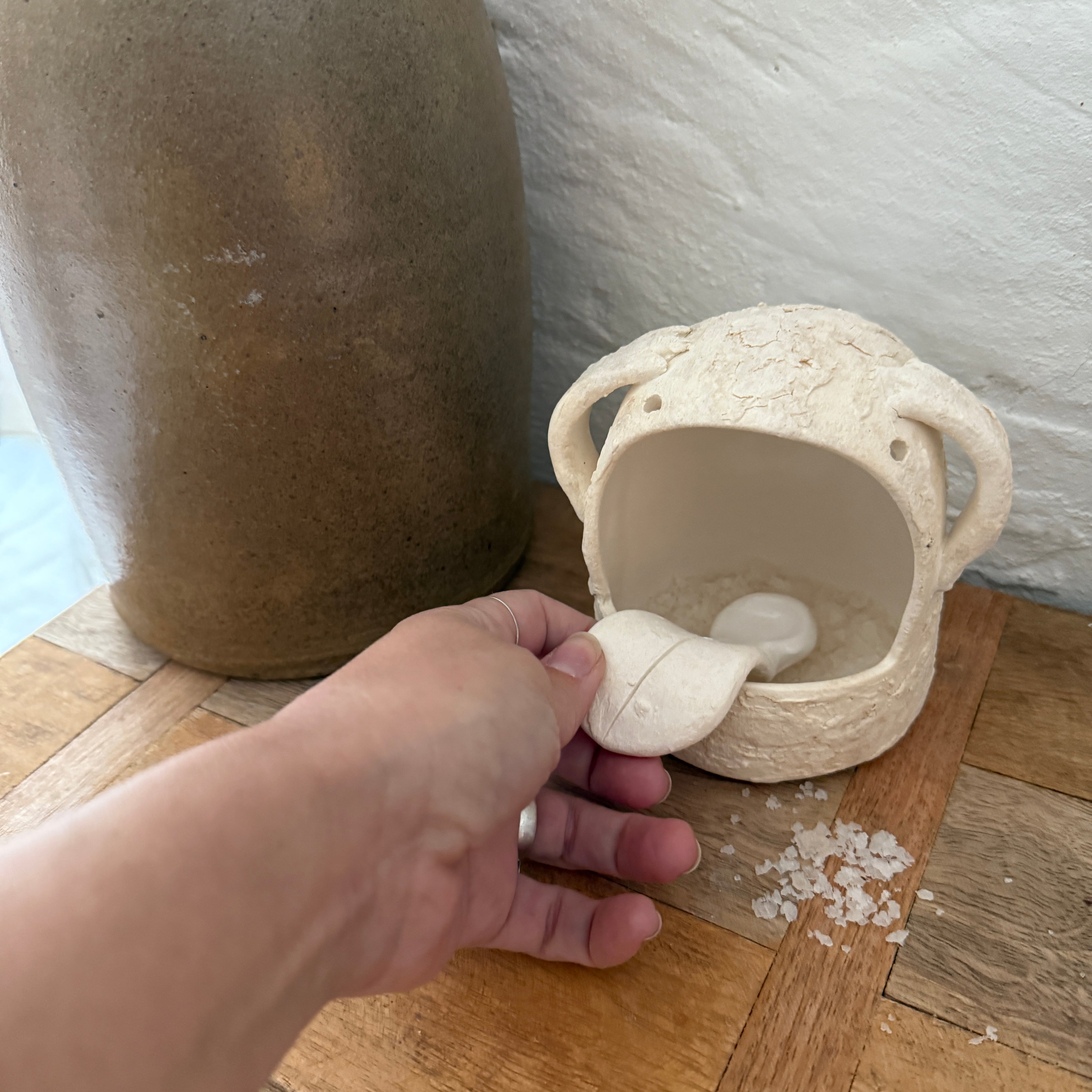 Whimsical handmade ceramic salt cellar shaped like Stanley, a googly-eyed monster