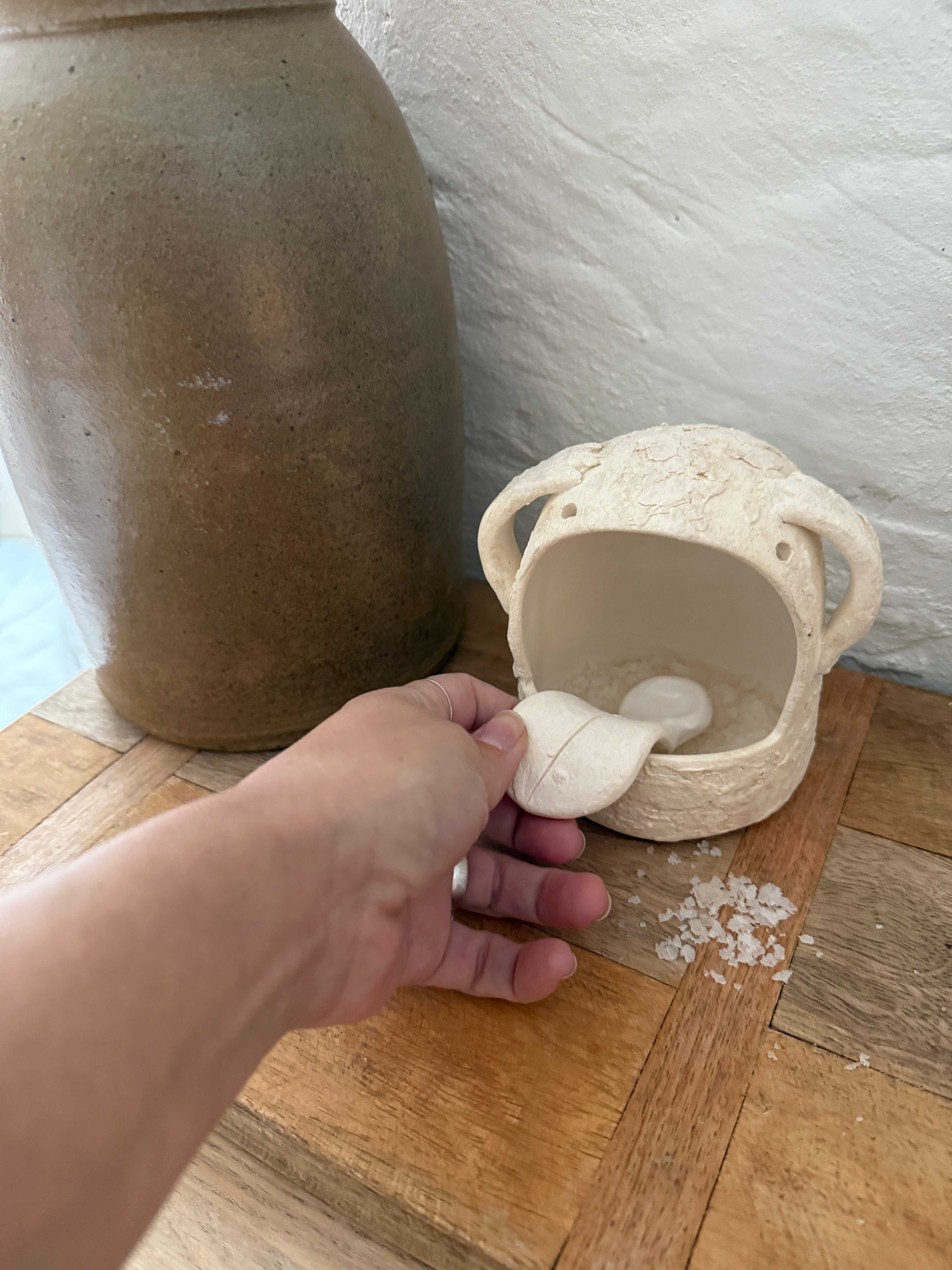 Whimsical handmade ceramic salt cellar shaped like Stanley, a googly-eyed monster
