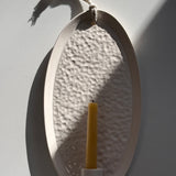 Handmade oval ceramic wall sconce taper candle holder with a dimpled hand-textured interior