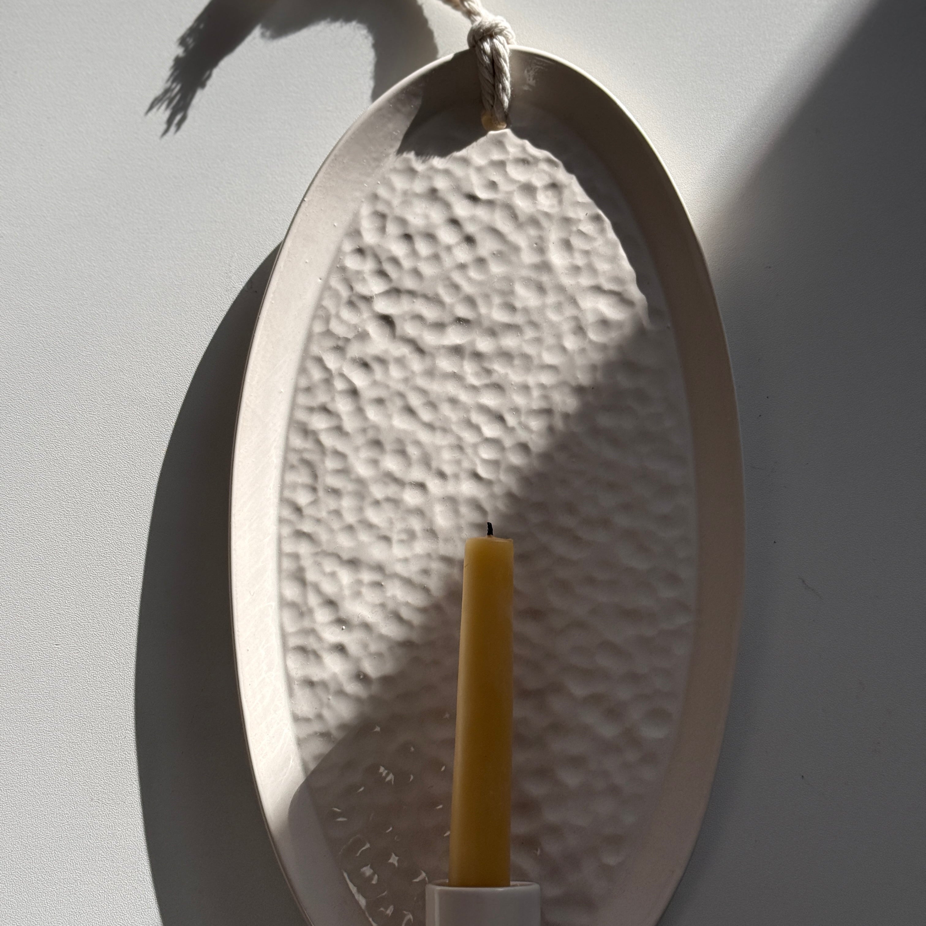 Handmade oval ceramic wall sconce taper candle holder with a dimpled hand-textured interior