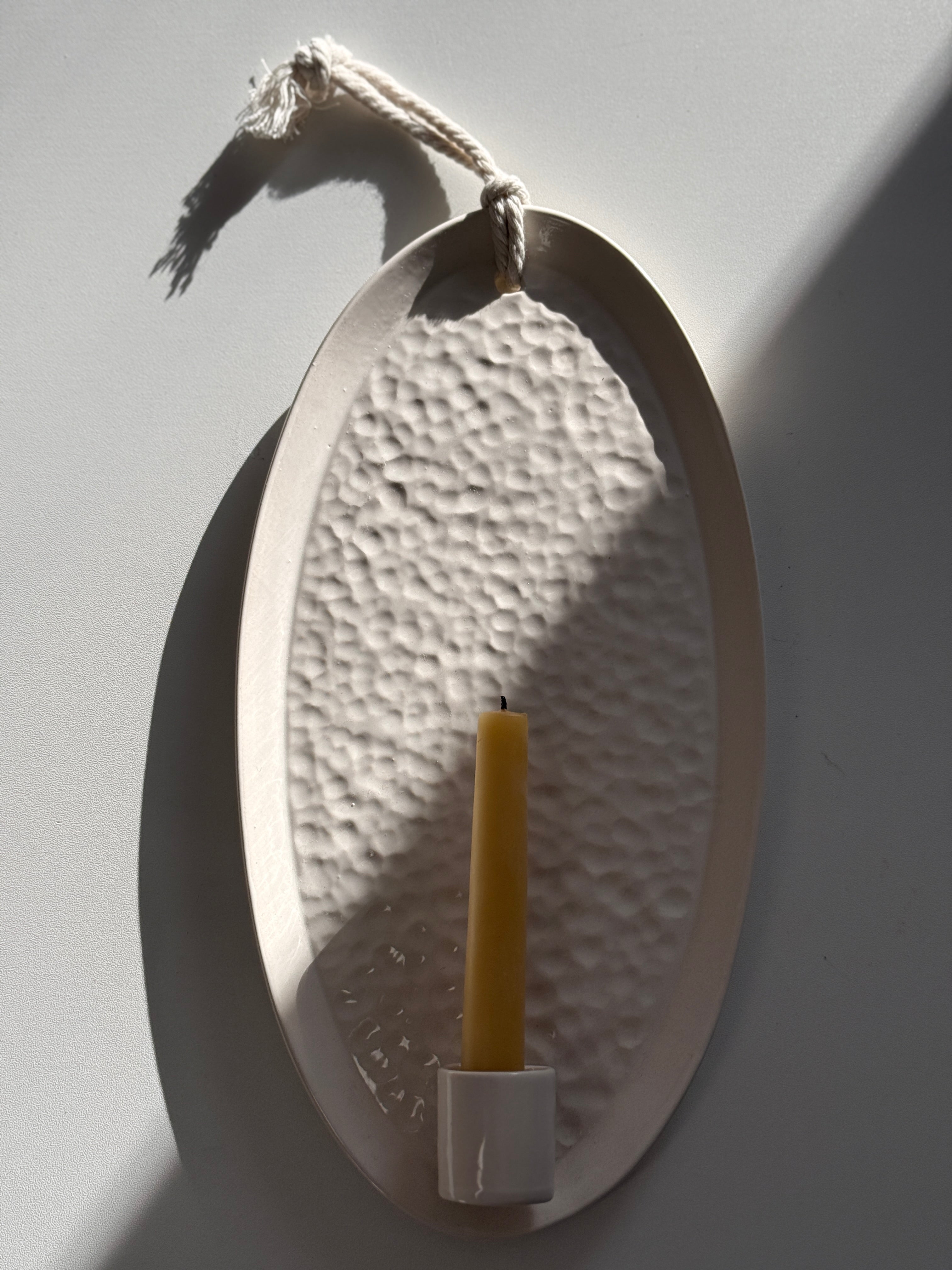 Handmade oval ceramic wall sconce taper candle holder with a dimpled hand-textured interior
