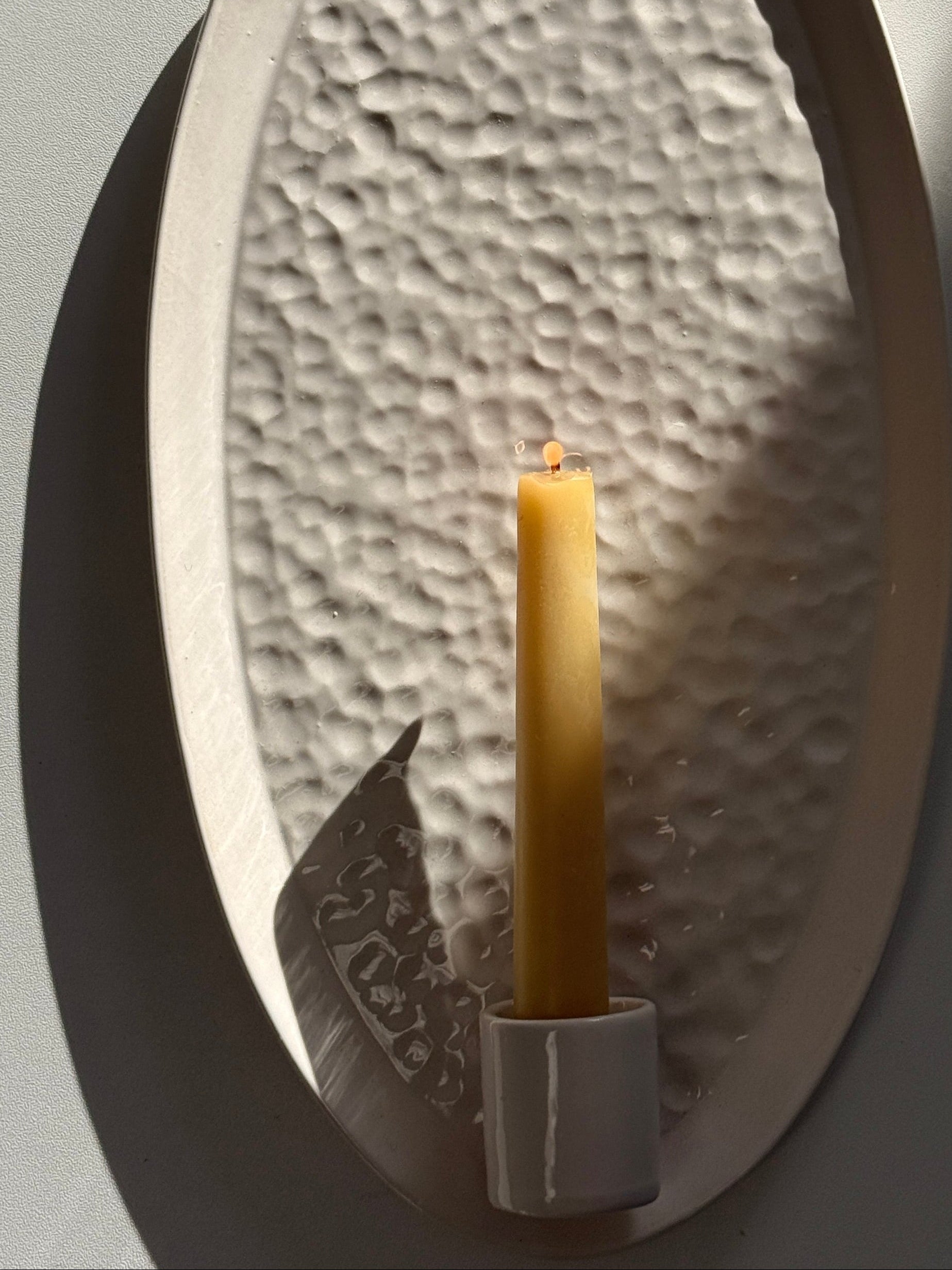 Handmade oval ceramic taper candle wall sconce, textured interior detail