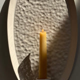 Oval ceramic wall sconce with a softly raised edge and rope hanger