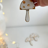 Handmade porcelain mushroom ornaments with 22K gold luster by Muddy Heart