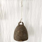 Large neutral-glaze ceramic campana bell styled on a porch