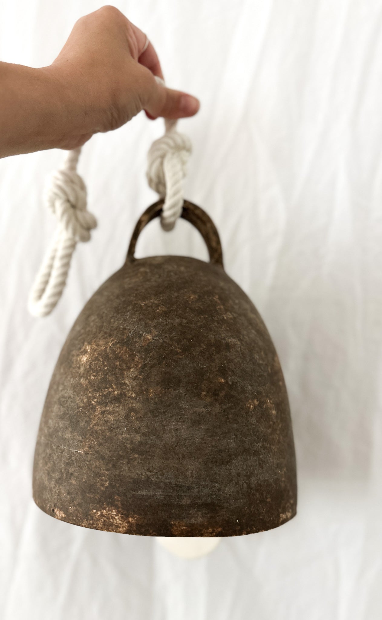 Substantial ceramic bell with a rounded campana shape, side view