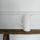 Rustic ceramic jug pitcher in a warm neutral glaze