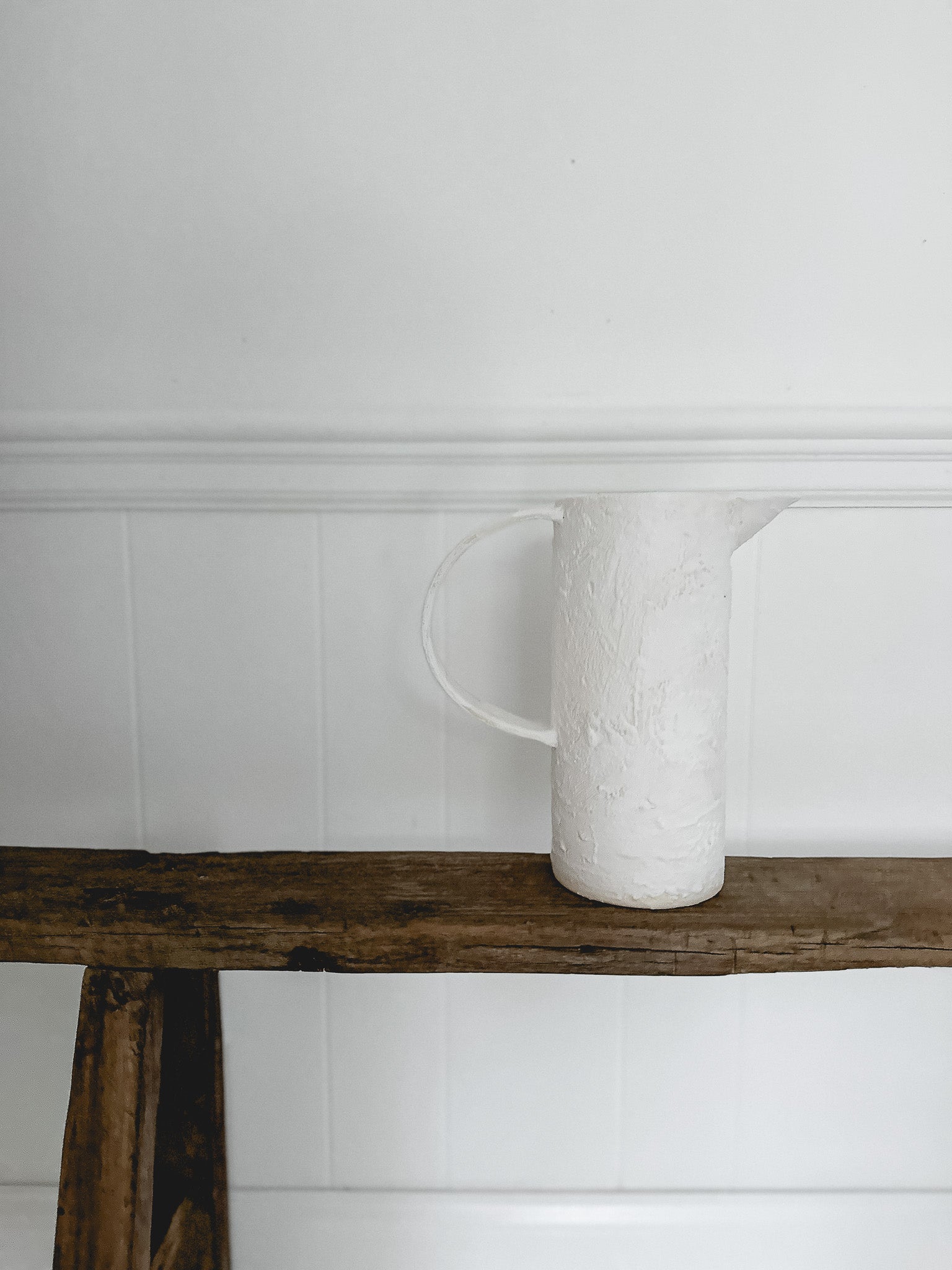 Rustic ceramic jug pitcher in a warm neutral glaze