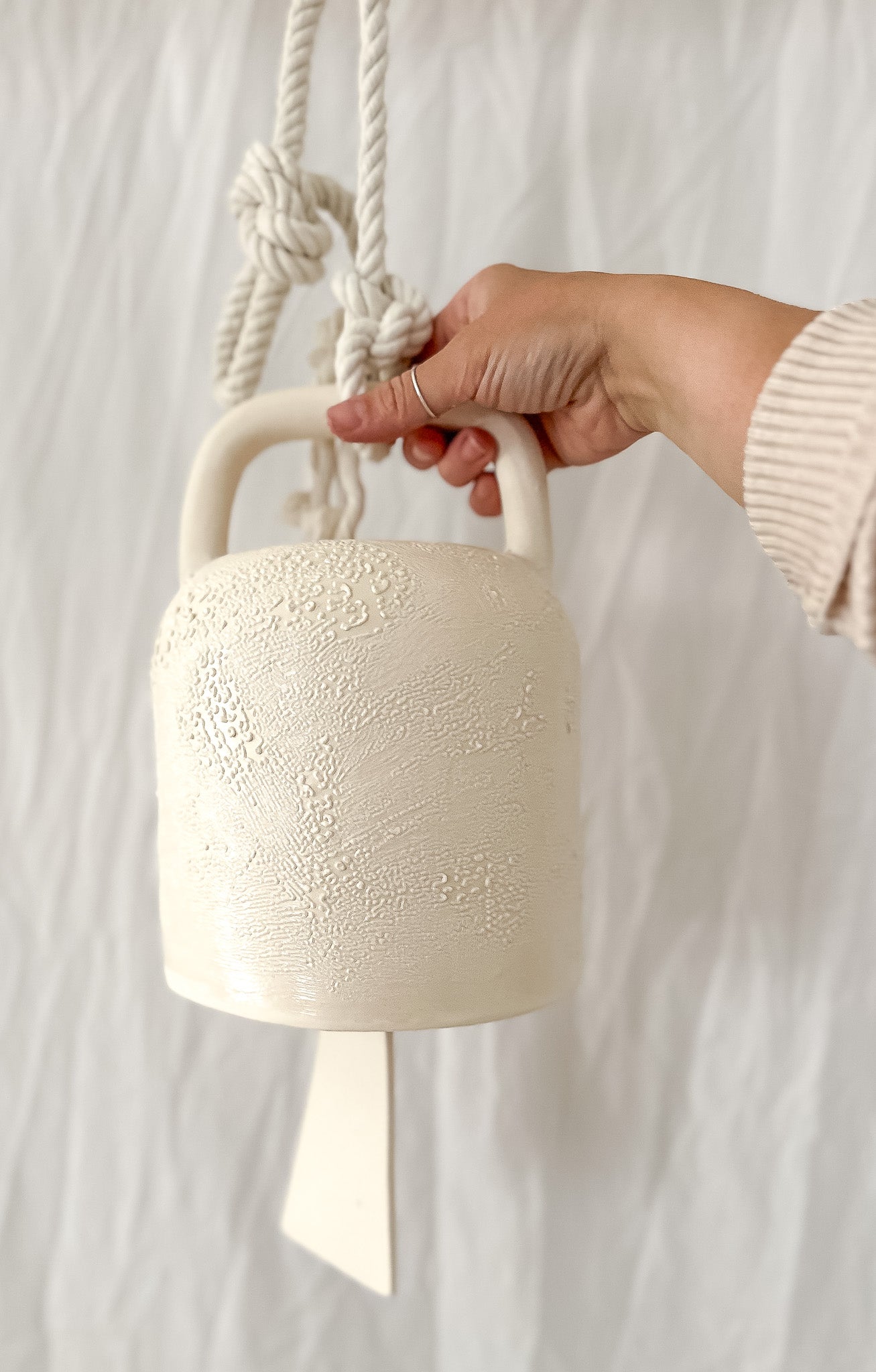 Textured white ceramic barrel bell, handcrafted with a soft, calming chime