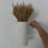 Handmade stoneware pitcher with a large looped handle for easy pouring
