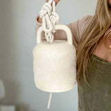 Textured white ceramic barrel bell with rope, for boho and farmhouse interiors