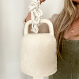 Handmade ceramic barrel bell with rope in a textured white glaze, for minimalist interiors