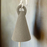 Tall spire-shaped ceramic bell, side view