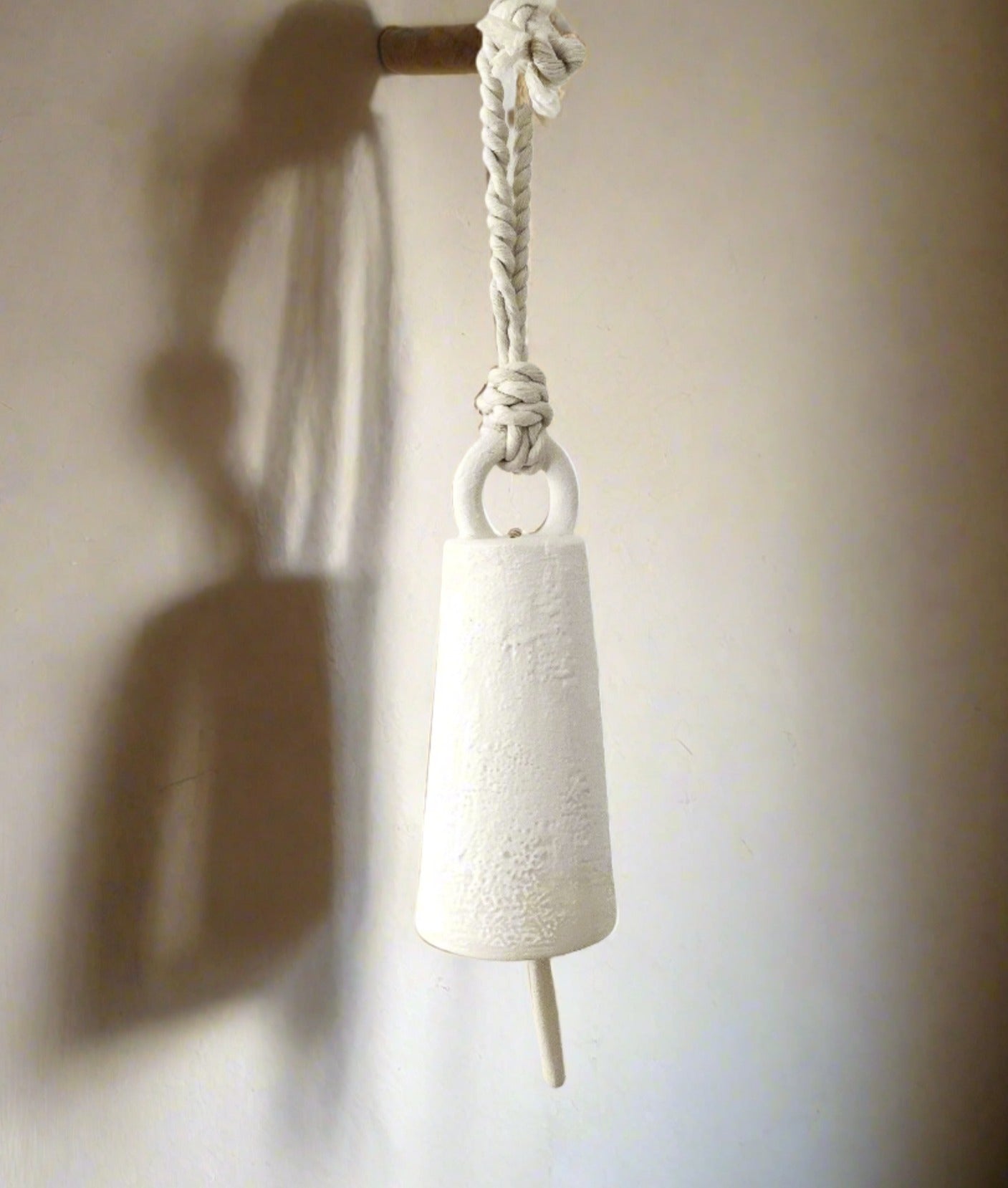 Spotlight-shaped ceramic bell, side view