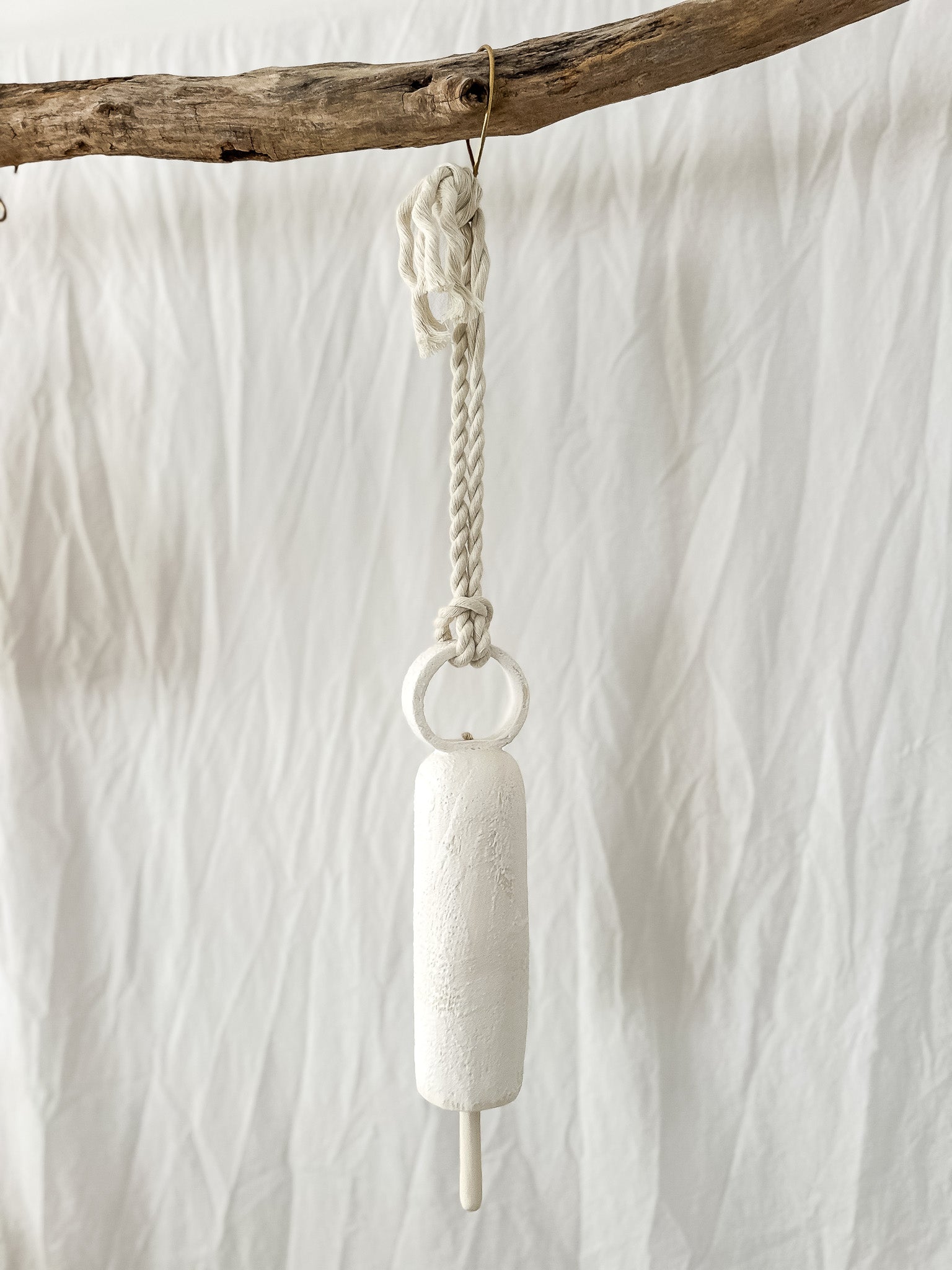 Close-up of the glaze on a handmade long round-handle ceramic bell