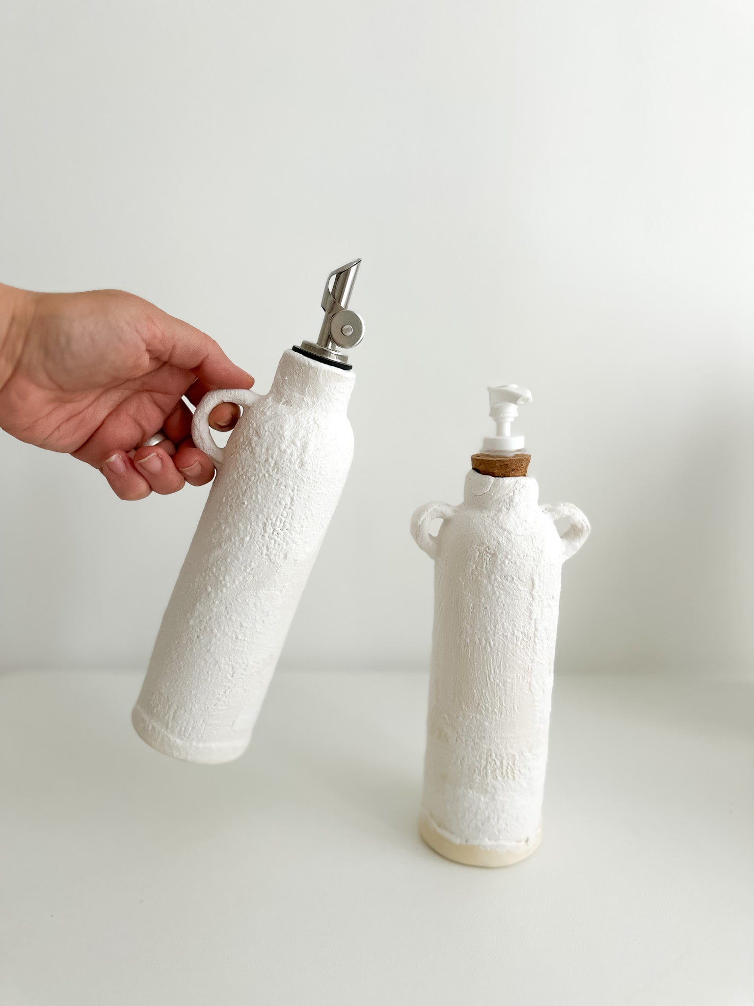 Neutral ceramic dispenser bottles, close-up of the pump top