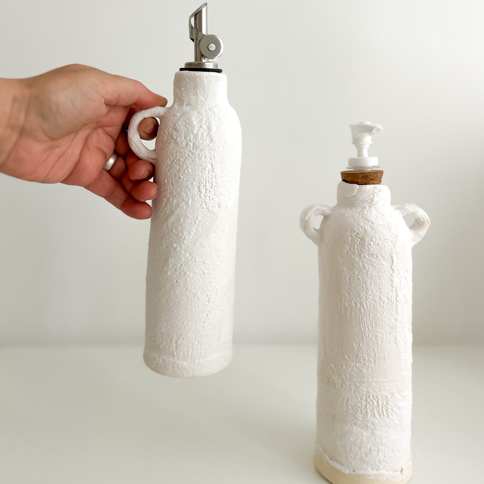 Handmade ceramic oil cruet and soap dispenser bottles with pump tops