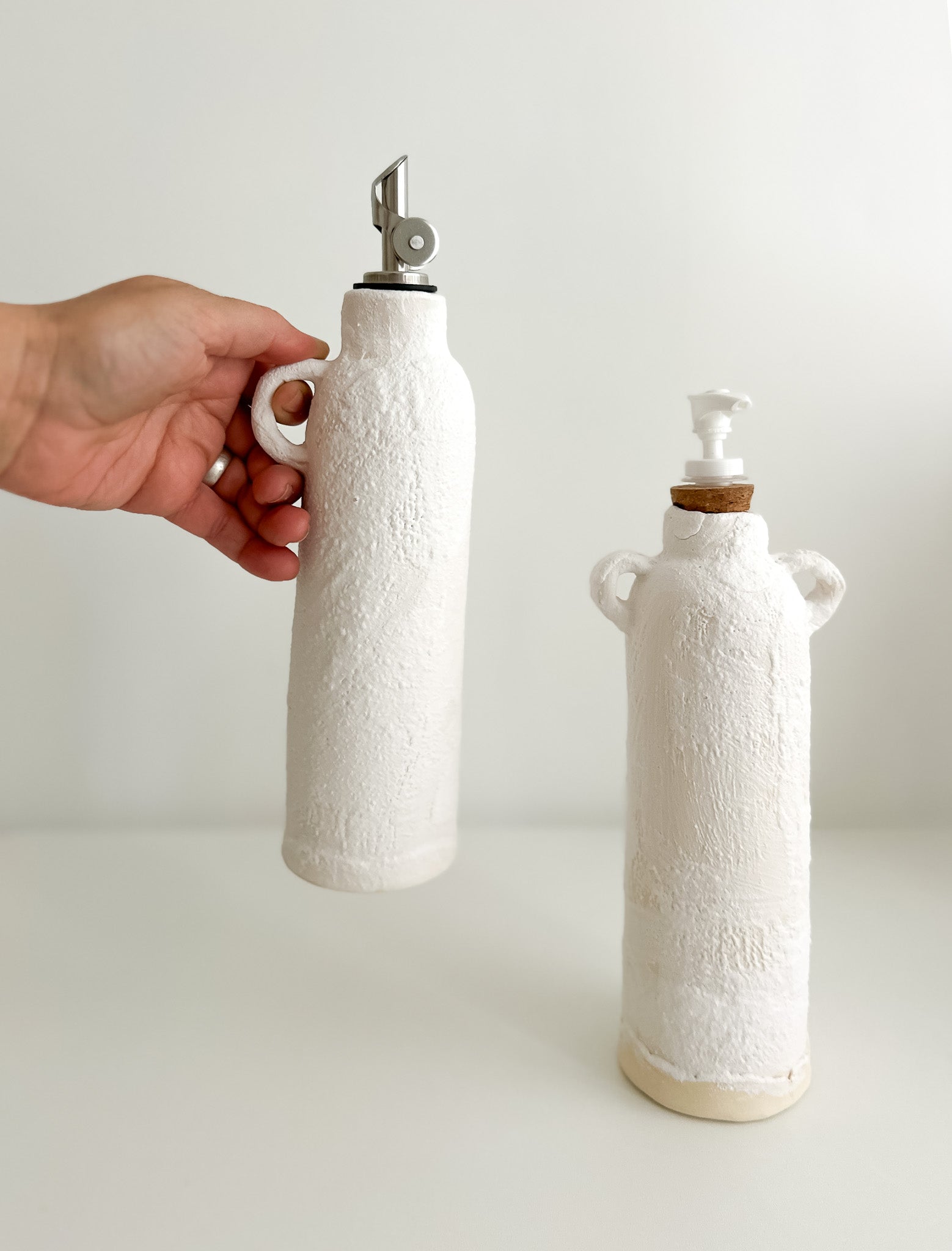 Handmade ceramic oil cruet and soap dispenser bottles with pump tops