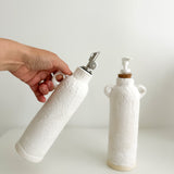 Ceramic soap dispenser and oil cruet set, side view