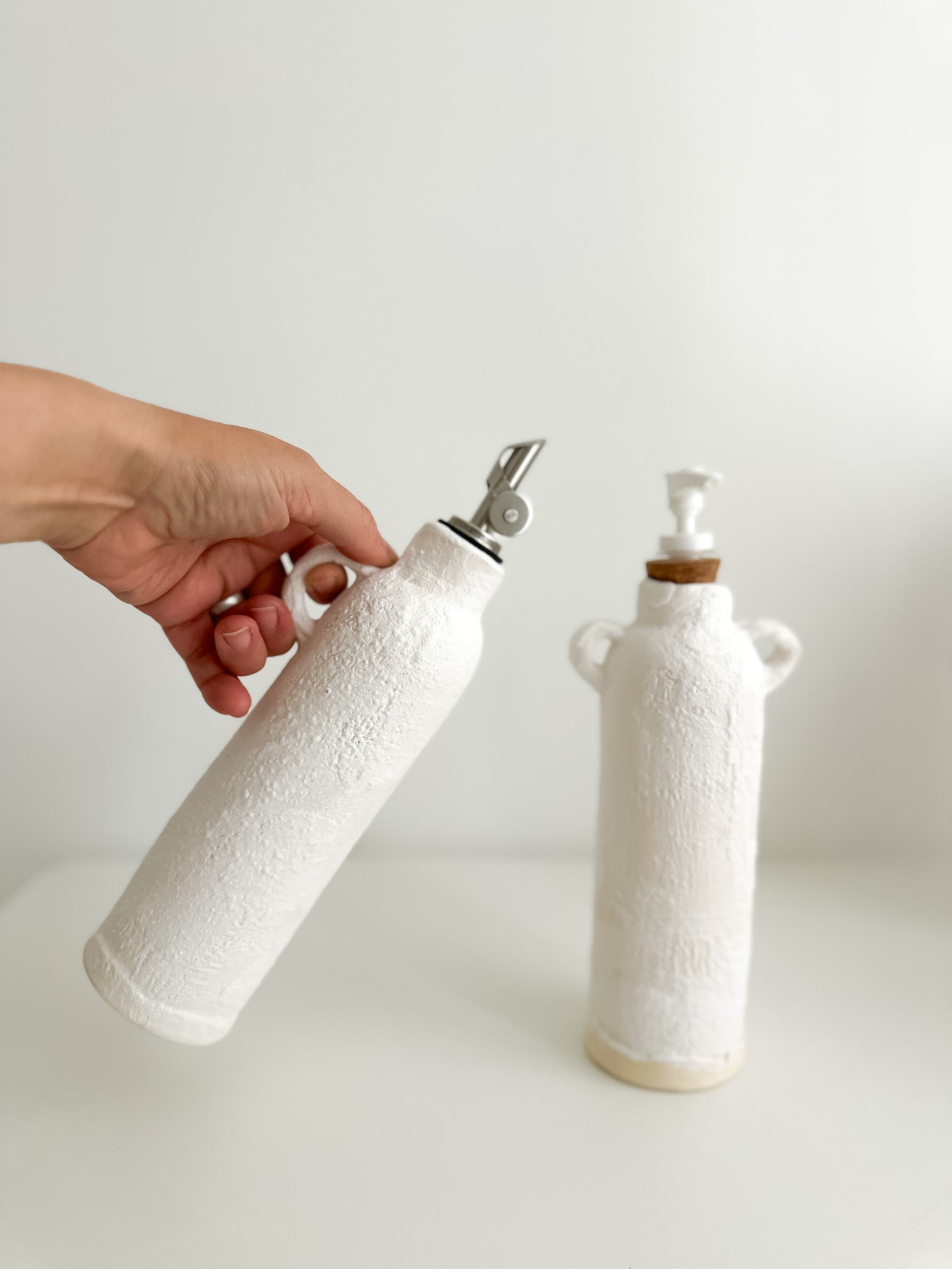 Ceramic soap dispenser and oil cruet set, side view