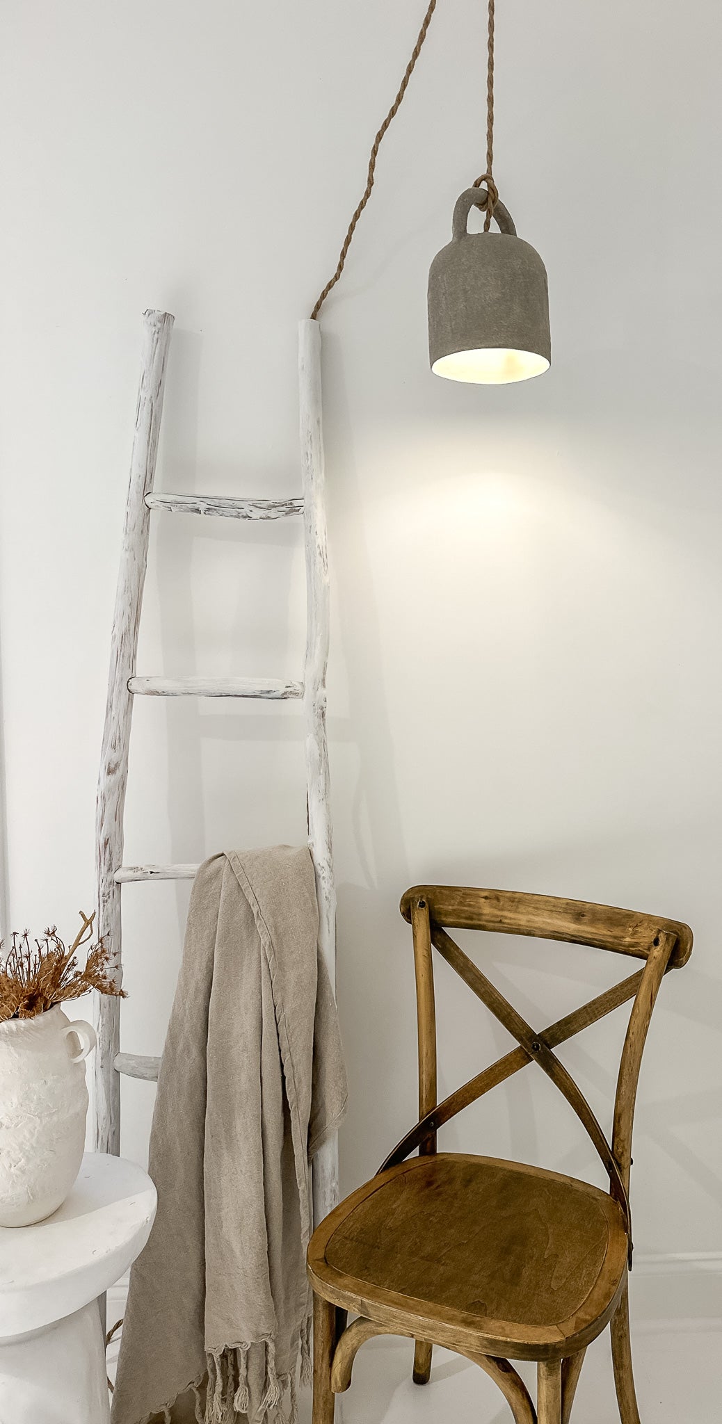 Neutral ceramic barrel pendant light shown lit