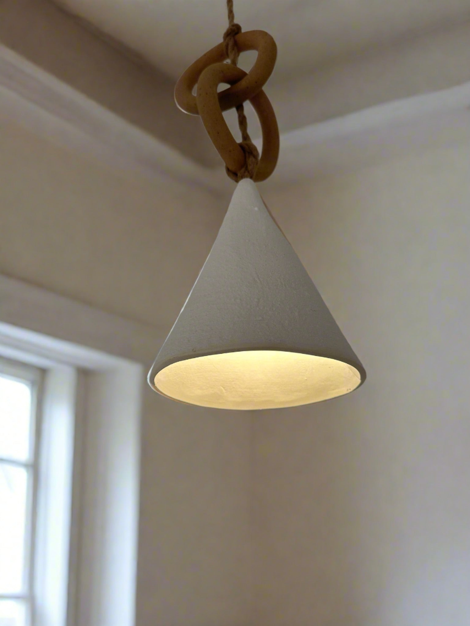 Handmade ceramic loops pendant light with a sculptural silhouette