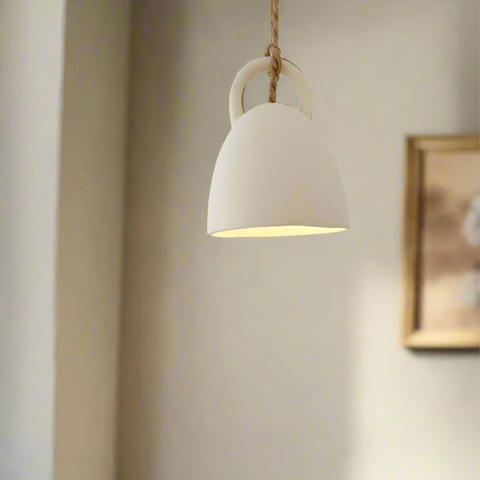 Handmade ceramic open-bell pendant light in a neutral glaze