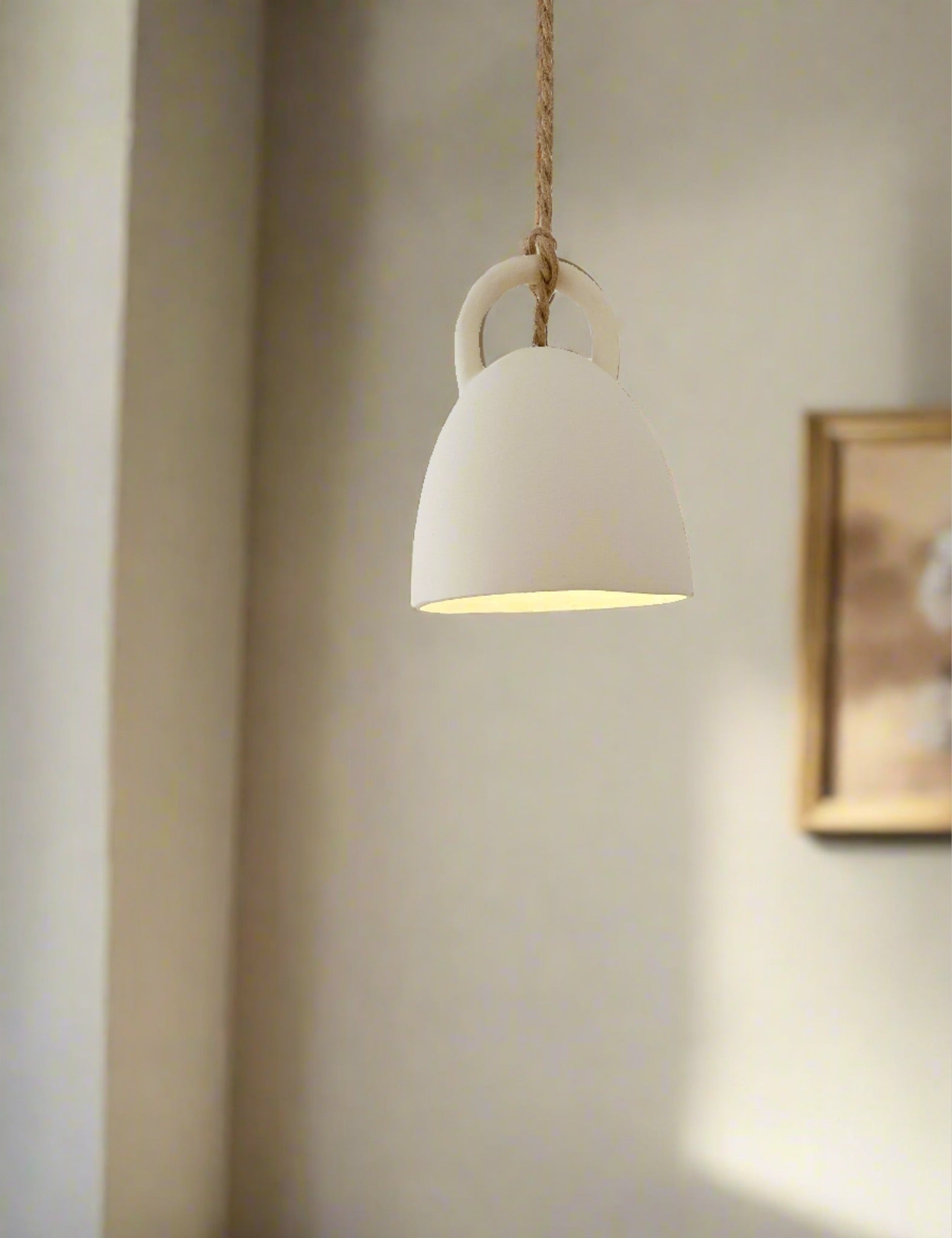 Handmade ceramic open-bell pendant light in a neutral glaze