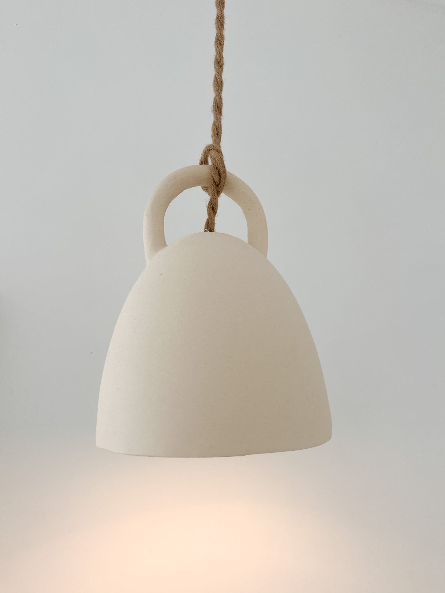 Neutral-glaze ceramic open-bell pendant lamp, close-up of the finish