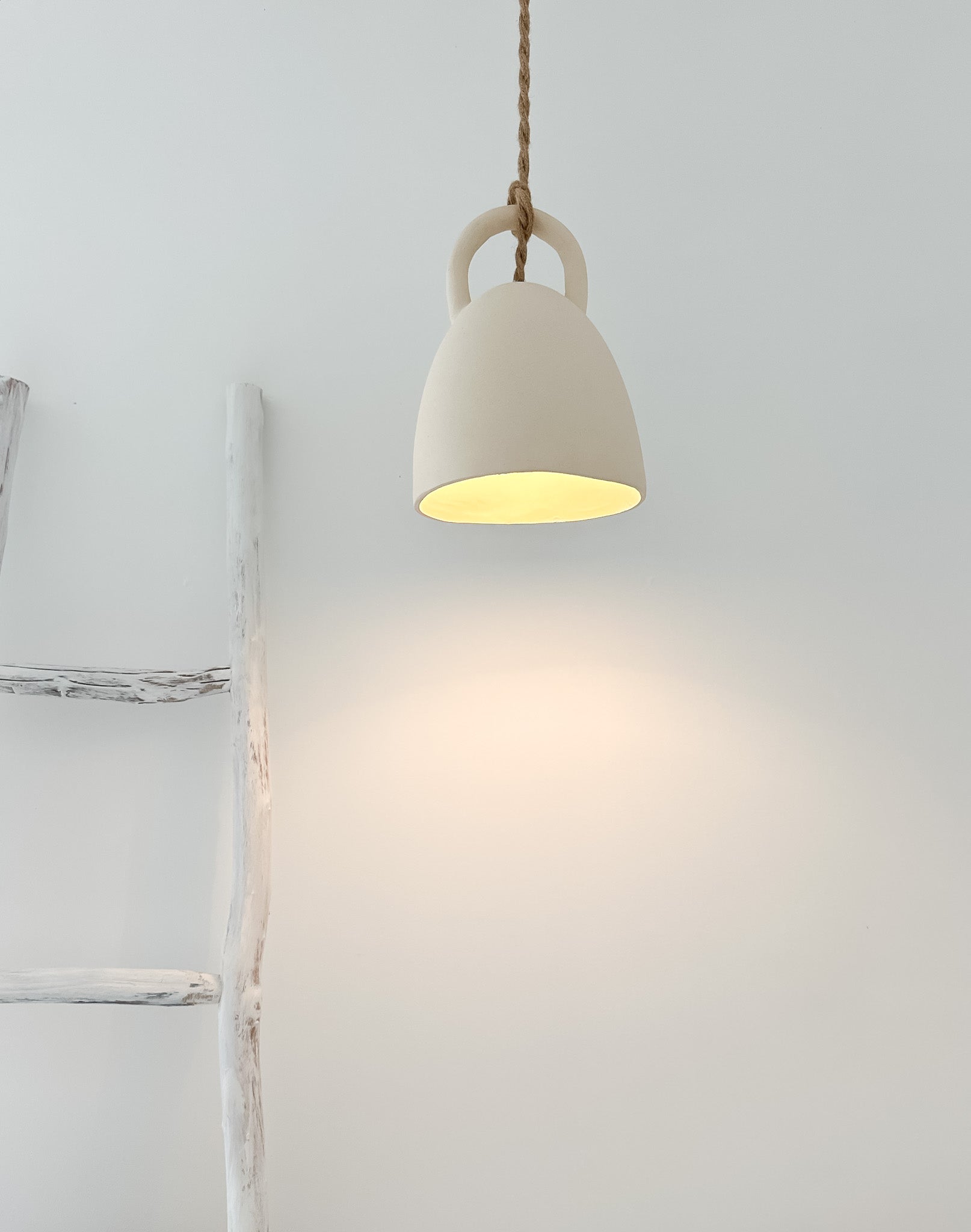 Open-bell pendant light styled over a kitchen island