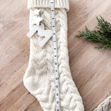 Knitted holiday stocking with an heirloom ceramic monogram