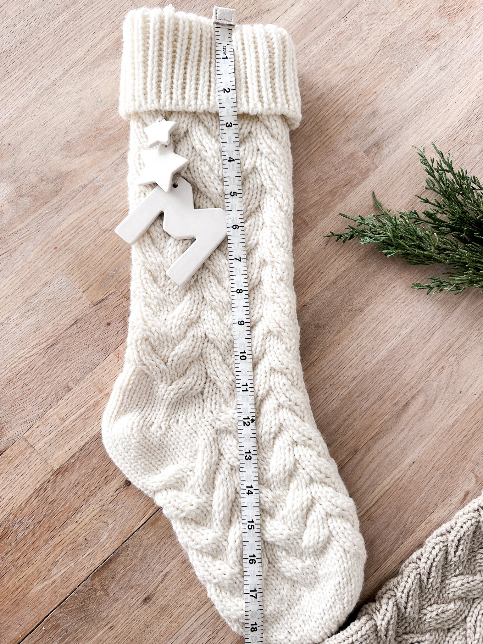 Knitted holiday stocking with an heirloom ceramic monogram