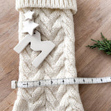 Handmade knit holiday stocking in cream with ceramic star detail