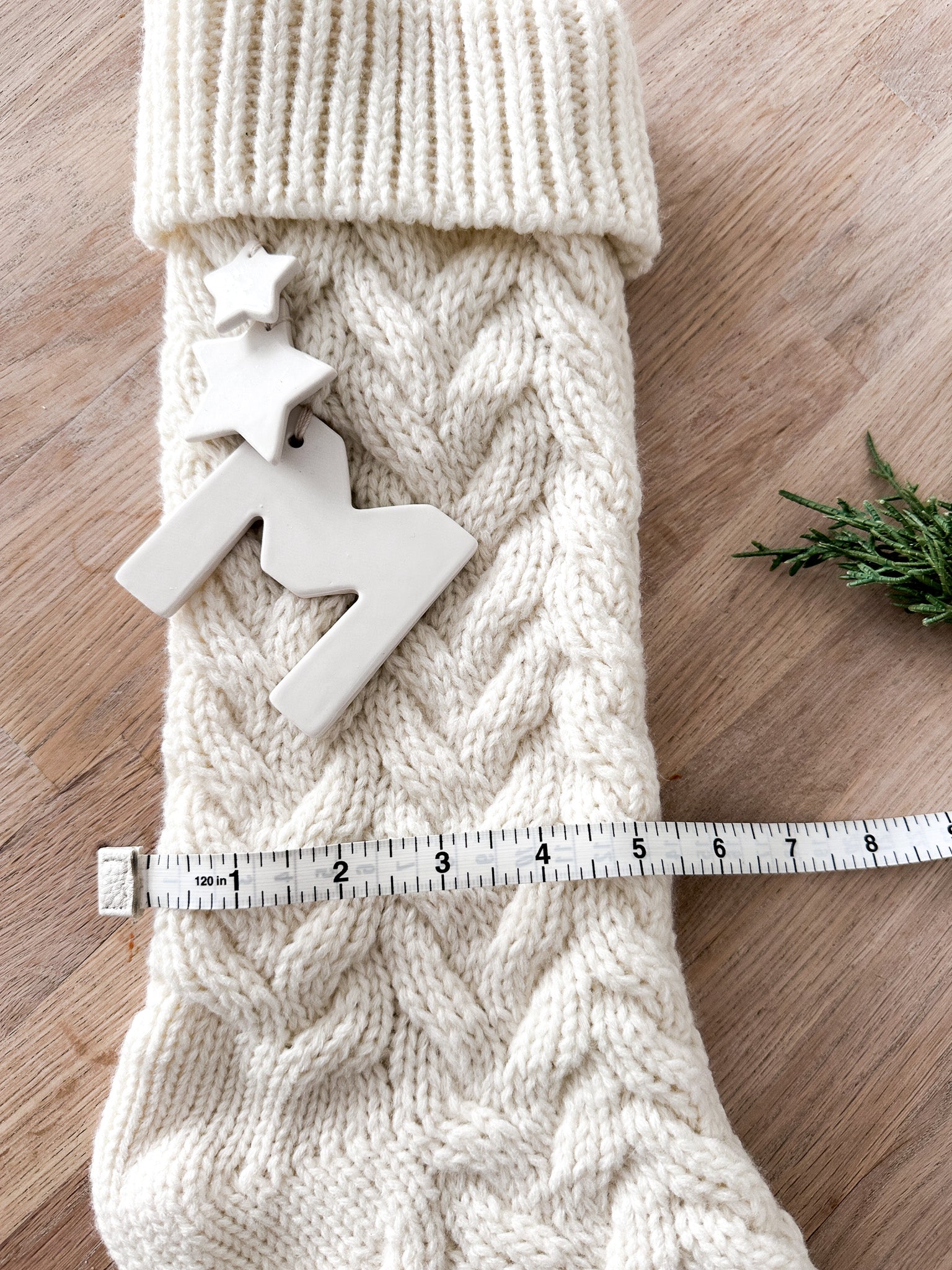 Handmade knit holiday stocking in cream with ceramic star detail