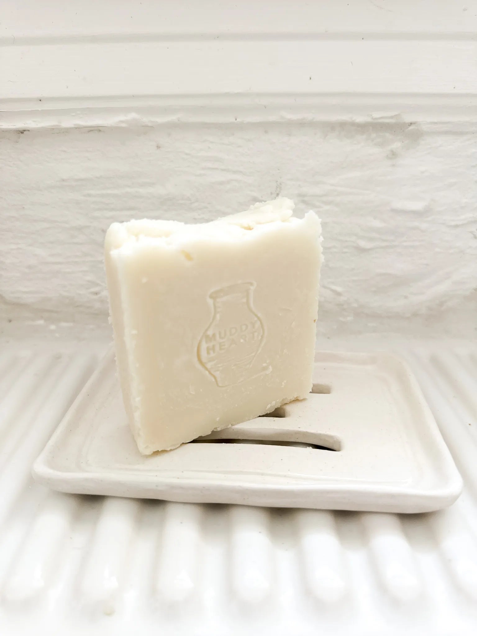 Handmade ceramic soap dish with a bar of olive oil Castile soap