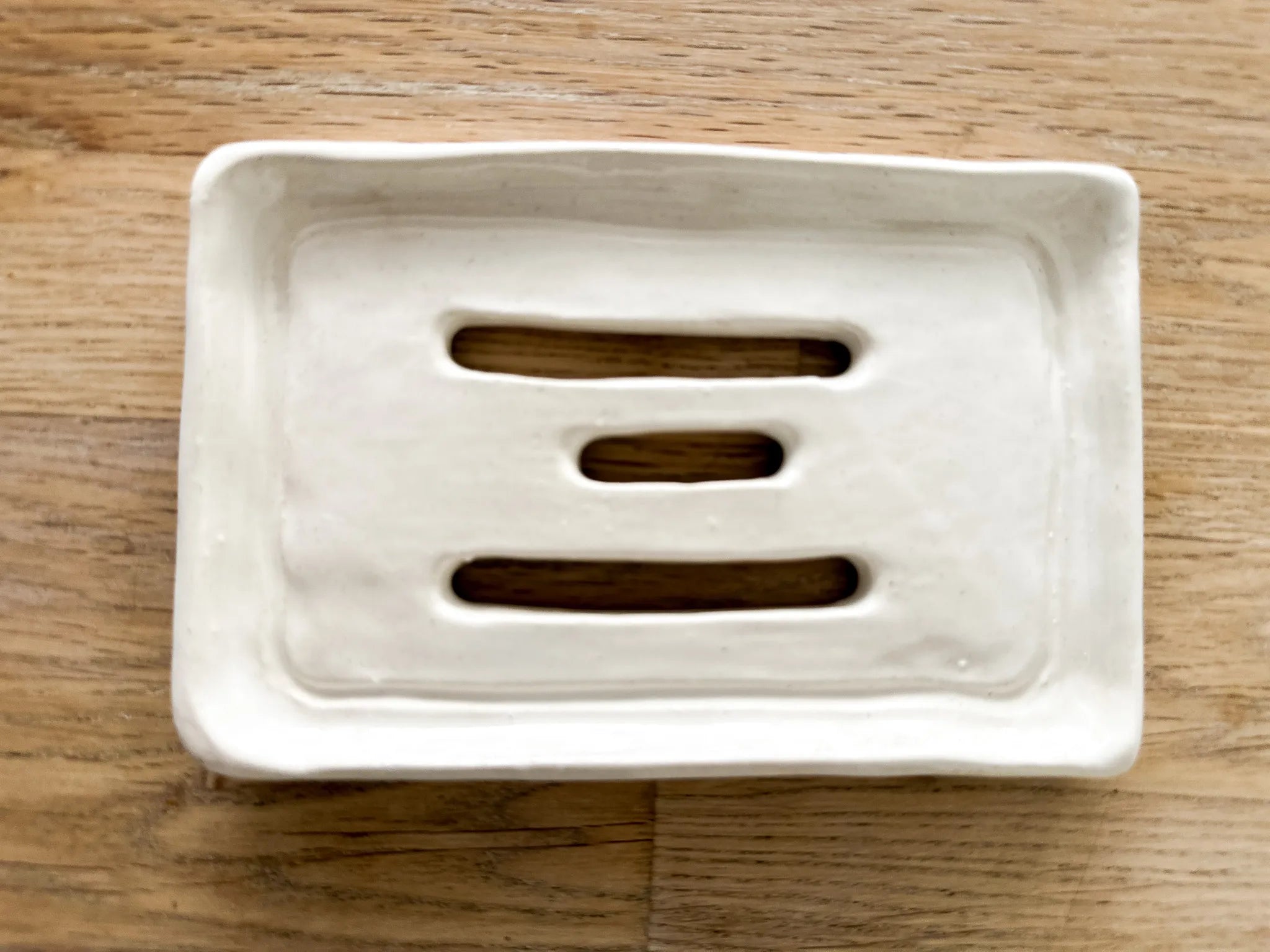 Olive oil Castile soap bar resting in a handmade ceramic dish