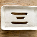 Olive oil Castile soap bar resting in a handmade ceramic dish