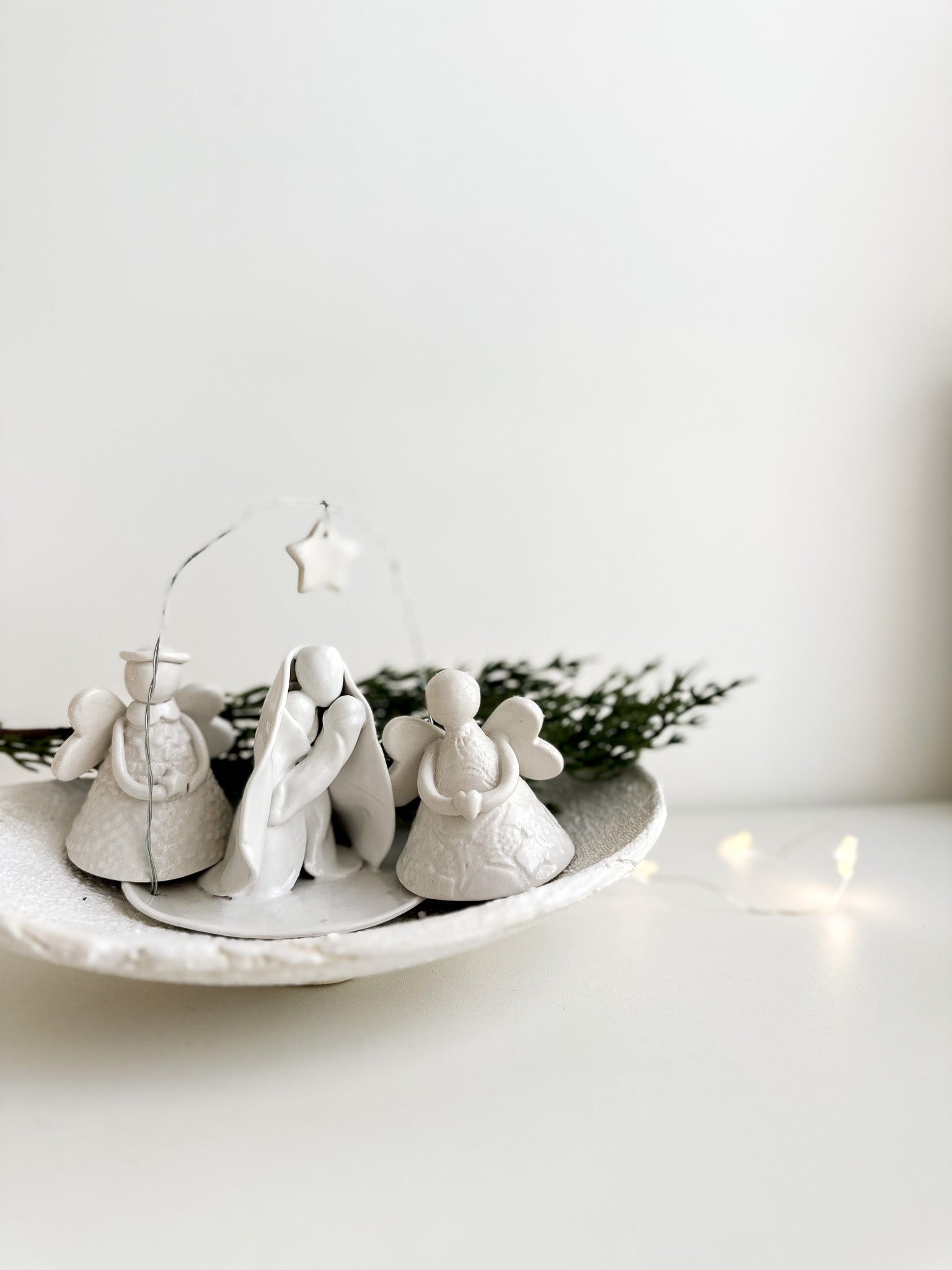 Footed ceramic dish styled with fresh fruit