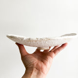 Elevated ceramic serving dish in a neutral finish